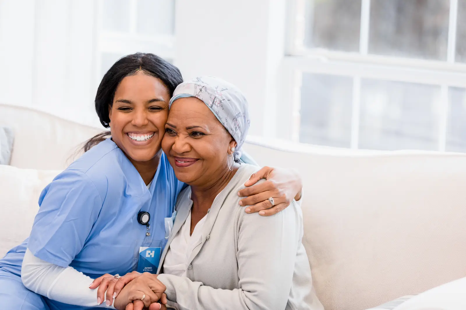 A caregiver embracing an older adult during a home visit.